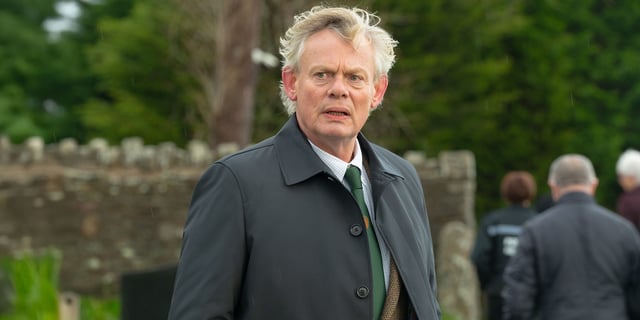 Martin Clunes looking worried in a suit in Out There