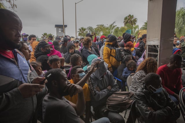 File photo: migrants gather for a rally at the U.S.-Mexico border.