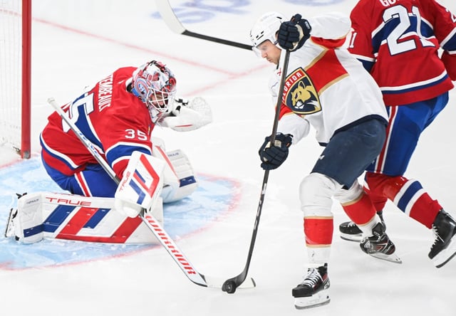 Florida Panthers&#39; Sam Reinhart (13) moves in on Montreal Canadiens goaltender Sam Montembeault during the second period of an NHL hockey game in Montreal, Tuesday, April 1, 2025. (Graham Hughes/The Canadian Press via AP)