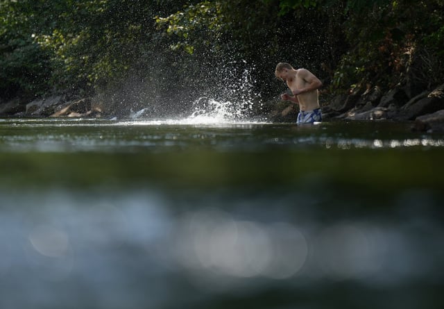 Environment Canada has issued a special weather statement in the North Thompson, saying "above seasonal temperatures" are expected. A person cools off in Lynn Creek in North Vancouver, B.C., on Thursday, July 6, 2023. THE CANADIAN PRESS/Darryl Dyck