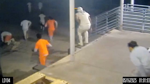 A screen grab taken from a handout CCTV video shows inmates running through the loading dock at the Orleans Parish Justice Center, in New Orleans, Louisiana on May 16, 2025.