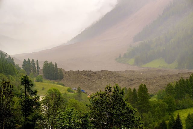 A large avalanche with a mixture of ice, rock, snow and water reach the valley floor is pictured in Wiler after the Birch glacier collapsing above Blatten, Switzerland, Wednesday, May 28, 2025. (Jean-Christophe Bott/Keystone via AP)