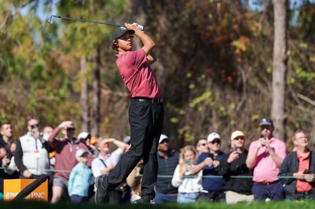 Dec 22, 2024; Orlando, Florida, [USA]; Charlie Woods hits a hole in one on the fourth hole during the PNC Championship at The Ritz-Carlton Golf Club. Mandatory Credit: Nathan Ray Seebeck-Imagn Images