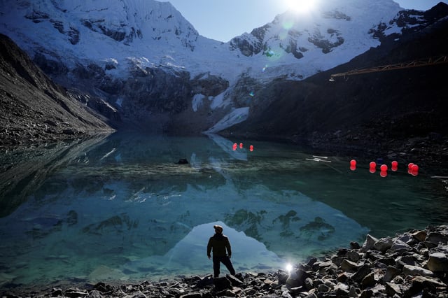 Peruvian farmer Saul Luciano Lliuya, who is suing German energy utility RWE, arguing that the company's emissions have contributed to the melting of Andean glaciers, stands by Lake Palcacocha, before the verdict of the high regional German court in Hamm, in Huaraz, Peru May 27, 2025. REUTERS/Angela Ponce/File Photo
