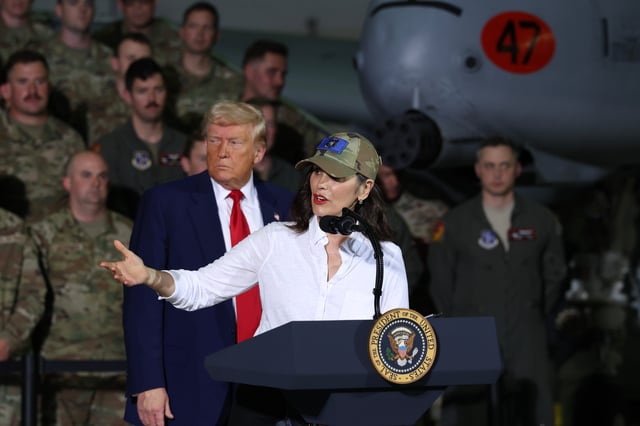 President Donald Trump listens as Michigan Gov. Gretchen Whitmer speaks during a visit with Michigan Air National Guard Troops on April 29, 2025 at Selfridge Air National Guard Base, Michigan. Trump will travel to Macomb Community College in Warren, Michigan to hold a rally where he is expected to highlight his accomplishments during his first 100 days in office, including closing the border, job creation and the economy.
