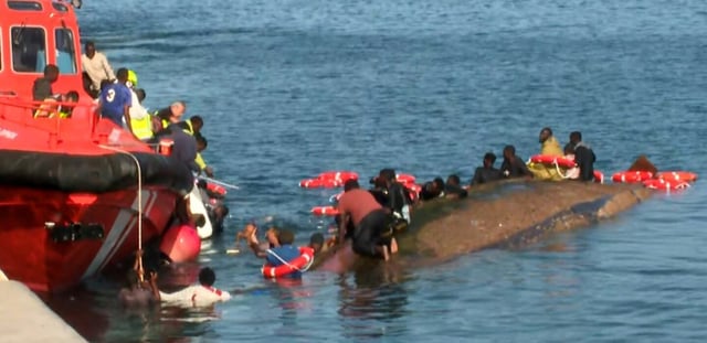 Image tirée d'une vidéo diffusée par Television Canaria montrant des sauveteurs tentant de sauver des migrants de la noyade après le chavirement de leur bateau surchargé, dans le port de La Restinga, sur l'île d'El Hierro, le 28 mai 2025 aux Canaries