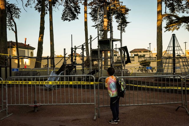 A child looks at the playground at Lincoln Park which partially burned down in San Francisco. San Francisco police arrested a person suspected of starting a fire at a park near near La Playa and Balboa streets. It was not clear if the person was suspected of starting the Lincoln Park fire. 