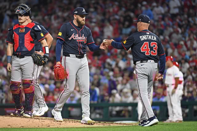 May 27, 2025; Philadelphia, Pennsylvania, USA; Atlanta Braves pitcher Dylan Lee (52) hands the ball to manager Brian Snitker (43) during the seventh inning against the Philadelphia Phillies at Citizens Bank Park. Mandatory Credit: Eric Hartline-Imagn Images