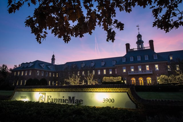 The sun sets behind the Fannie Mae headquarters in Washington. One of the chief concerns of taking Fannie Mae and Freddie Mac private is how it would influence mortgage rates and could increase their costs. (J. DAVID AKE/AP FILE)
