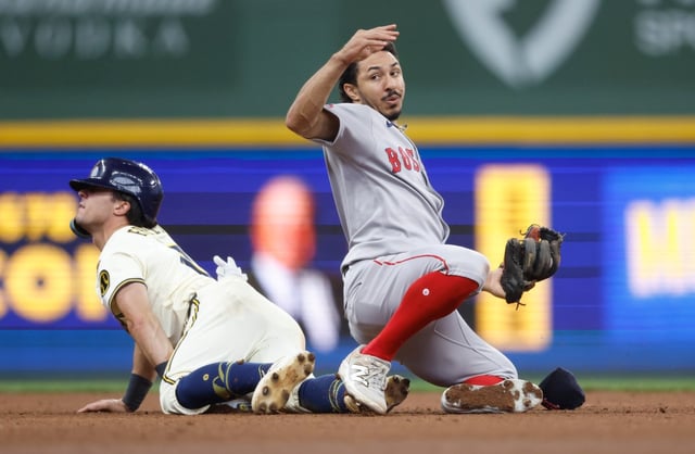 Milwaukee Brewers’ Sal Frelick, left, slides in safely to second base ahead of the tag by Boston Red Sox’s David Hamilton during the sixth inning of a  game Wednesday in  Milwaukee. (AP Photo/Jeffrey Phelps)