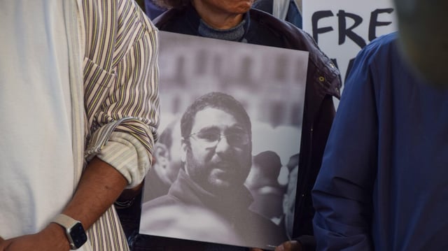 A protester holds a picture of Alaa Abd-El Fattah, the British-Egyptian human rights activist who is imprisoned in Egypt