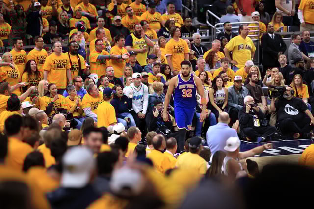 Karl-Anthony Towns #32 of the New York Knicks reacts after dunking the ball against Andrew Nembhard #2 and Myles Turner #33 of the Indiana Pacers during the fourth quarter in Game Three of the Eastern Conference Finals of the 2025 NBA Playoffs at Gainbridge Fieldhouse on May 25, 2025 in Indianapolis, Indiana.