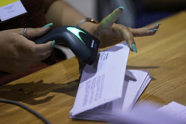 Volunteers register envelopes from Rio de Janeiro, Brazil, which contain votes for Portugal's May 18 general election, on the final day of counting of ballots from voters who live abroad, in Lisbon, Wednesday, May 28, 2025. (AP Photo/Armando Franca)