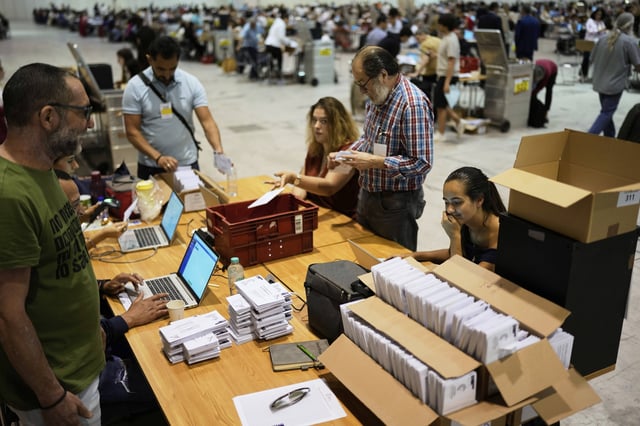 Volunteers register envelopes from Rio de Janeiro, Brazil, which contain votes for Portugal's May 18 general election, on the final day of counting of ballots from voters who live abroad, in Lisbon, Wednesday, May 28, 2025. (AP Photo/Armando Franca)