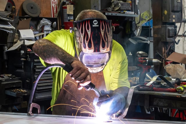 A worker arc welds a metal door during production at a facility in Sacramento, Calif., on May 27, 2025.