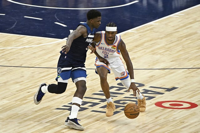 Shai Gilgeous-Alexander #2 of the Oklahoma City Thunder dribbles against Anthony Edwards #5 of the Minnesota Timberwolves during the second quarter in Game Four of the Western Conference Finals of the 2025 NBA Playoffs at Target Center on May 26, 2025 in Minneapolis, Minnesota.