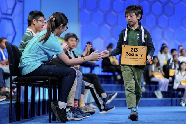 Zachary Ji-Hsien Teoh, 8, of Houston, walks off stage after making a mistake during the quarterfinals of the Scripps National Spelling Bee, Wednesday, May 28, 2025, in Oxon Hill, Md. (AP Photo/Julia Demaree Nikhinson)