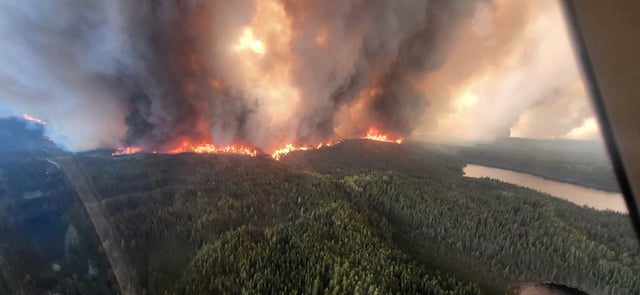 Smoke rises from the WE017 wildfire, which has prompted a state of emergency and evacuation of Sherridon, Manitoba, Canada May 27, 2025. Manitoba Government/Handout via REUTERS/File Photo