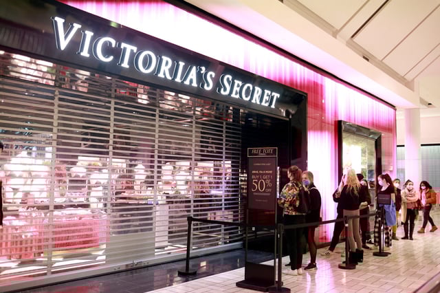 Shoppers stand in line as they wait for a Victoria's Secret store to open on Black Friday in Tysons, Virginia on Nov. 27, 2020.