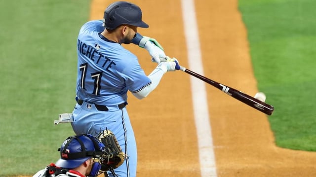 May 28, 2025; Arlington, Texas, USA; Toronto Blue Jays shortstop Bo Bichette (11) hits a two-run home run during the ninth inning against the Texas Rangers at Globe Life Field. Mandatory Credit: Kevin Jairaj-Imagn Images