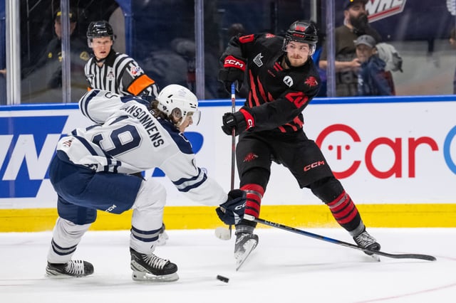 PHOTO COURTESY VICNENT ETHIER/CHL Moncton Wildcats' forward Preston Lounsbury makes a pass around Rimouski Oceanic defenceman Basile Sansonnens, Wednesday in the final round robin game of the 105th Memorial Cup hosted in Rimouski, Que.