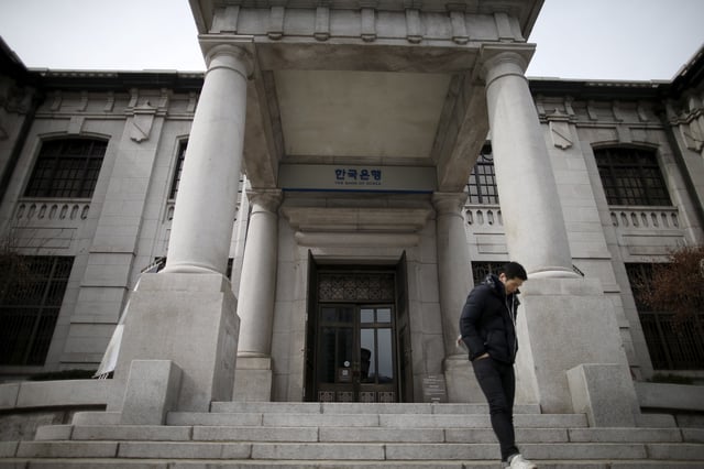 A man stands in front of the Bank of Korea in Seoul, South Korea, March 8, 2016. Picture taken on March 8, 2016.  REUTERS/Kim Hong-Ji/ File Photo