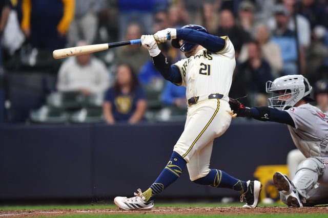 May 28, 2025; Milwaukee, Wisconsin, USA; Milwaukee Brewers third baseman Caleb Durbin (21) hits an RBI sacrifice fly ball during the tenth inning against the Boston Red Sox at American Family Field. Mandatory Credit: Patrick Gorski-Imagn Images