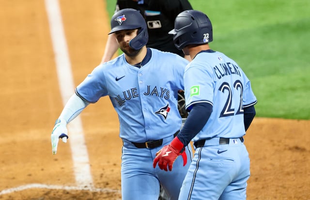 May 28, 2025; Arlington, Texas, USA; Toronto Blue Jays shortstop Bo Bichette (11) celebrates with Toronto Blue Jays shortstop Ernie Clement (22) after hitting a two-run home run during the ninth inning against the Texas Rangers at Globe Life Field. Mandatory Credit: Kevin Jairaj-Imagn Images