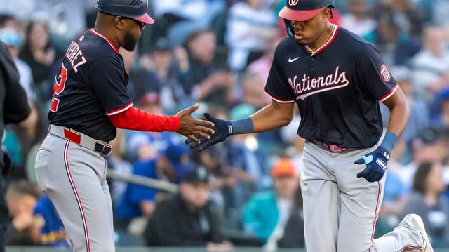 May 27, 2025; Seattle, Washington, USA;  Washington Nationals left fielder James Wood (29) is congratulated by third base coach Ricky Gutierrez after hitting a solo home run during the fourth inning against the Seattle Mariners at T-Mobile Park. Mandatory Credit: Stephen Brashear-Imagn Images