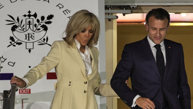 Emmanuel Macron & his wife's shocking conversation after shoving incident decoded by lip reader (Photo by YASUYOSHI CHIBA / AFP)