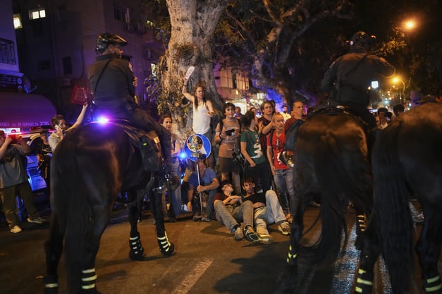 Israeli mounted police disperse demonstrators blocking a road during a protest marking 600 days since Israeli hostages were taken by Hamas into the Gaza Strip, call for their release and an end to the war, in Tel Aviv, Israel, on Wednesday, May 28, 2025. (AP Photo/Ohad Zwigenberg)