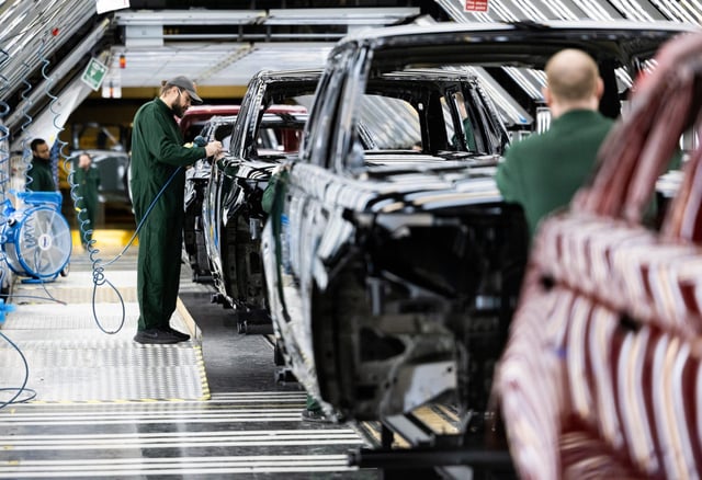 An employee polishes paint on the bodywork of a Range Rover sports utility vehicle (SUV) in the paint shop at Tata Motors Ltd.&#39;s Jaguar Land Rover vehicle manufacturing plant in Solihull, U.K.