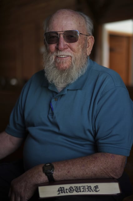 Oscar McGuire poses for a portrait with his copy of "The Sacred Harp" songbook at Holly Springs Primitive Baptist Church in Bremen, Ga., on Saturday, March 22, 2025. (AP Photo/Jessie Wardarski)