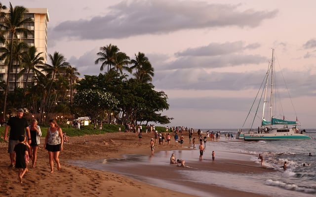 People gather on Kaanapali Beach, a popular tourist destination, on August 5, 2024 near Lahaina, Hawaii.