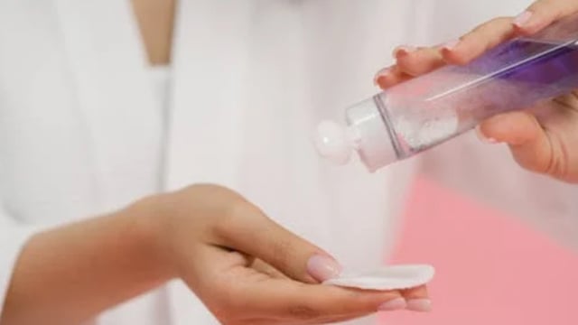 The embarrassed woman wiped off her makeup as an airport staffer scolded her.
