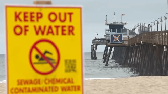 A sign warning swimmers to stay out of the water in Imperial Beach. 