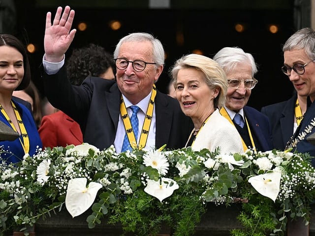 European Commission President Ursula Von der Leyen (C-R) and former European Commission President Jean-Claude Juncker (C-L) wave from the balcony of the town hall near exiled Belarusian opposition leader Svetlana Tikhanovskaya after Ursula Von der Leyen received the International Charlemagne Prize of Aachen 2025 (Karlspreis) from Mayor of Aachen Sibylle Keupen (R) on May 29, 2025 in Aachen, western Germany. The International Charlemagne Prize of Aachen, the oldest and best-known prize awarded for work done in the service of European unification, is awarded to European Commission President Ursula Von der Leyen. (Photo by INA FASSBENDER / AFP) (Photo by INA FASSBENDER/AFP via Getty Images)