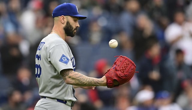 Dodgers relief pitcher Tanner Scott tosses a baseball after a two-run single by the Cleveland Guardians’ Nolan Jones during the eighth inning on Wednesday in Cleveland. The left-hander has five blown saves already this season, three in his past five appearances. (AP Photo/David Dermer)