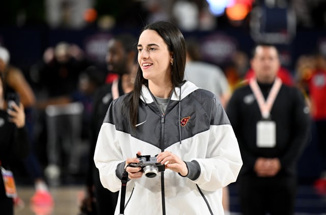 Caitlin Clark #22 of the Indiana Fever watches her team warm up before the game against the Washington Mystics at CFG Bank Arena on May 28, 2025 in Baltimore, Maryland.