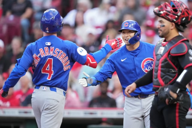 CINCINNATI, OHIO - MAY 23: Pete Crow-Armstrong #4 of the Chicago Cubs celebrates with teammate Seiya Suzuki #27 after hitting a two-run home run during the fourth inning of a baseball game against the Cincinnati Reds at Great American Ball Park on May 23, 2025 in Cincinnati, Ohio