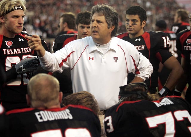 Texas Tech head coach Mike Leach talks with his team in the second quarter of an NCAA college football game against Texas A&amp;M in Lubbock, Texas, Saturday, Oct. 24, 2009.