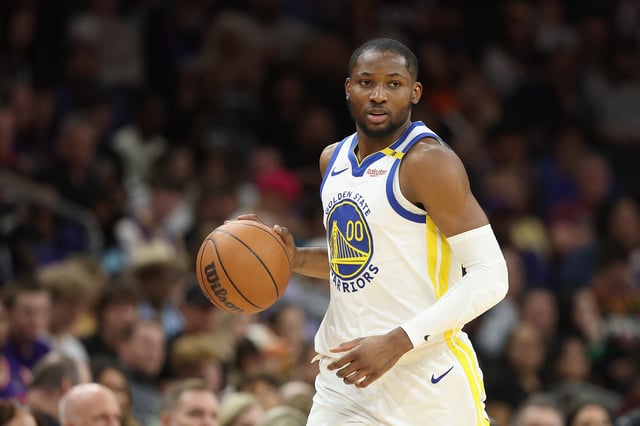 Jonathan Kuminga #00 of the Golden State Warriors handles the ball during the NBA game at PHX Arena on April 08, 2025 in Phoenix, Arizona.