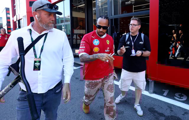 Formula One F1 - Spanish Grand Prix - Circuit de Barcelona-Catalunya, Barcelona, Spain - May 29, 2025 Ferrari's Lewis Hamilton with a fan ahead of the Spanish Grand Prix REUTERS/Albert Gea