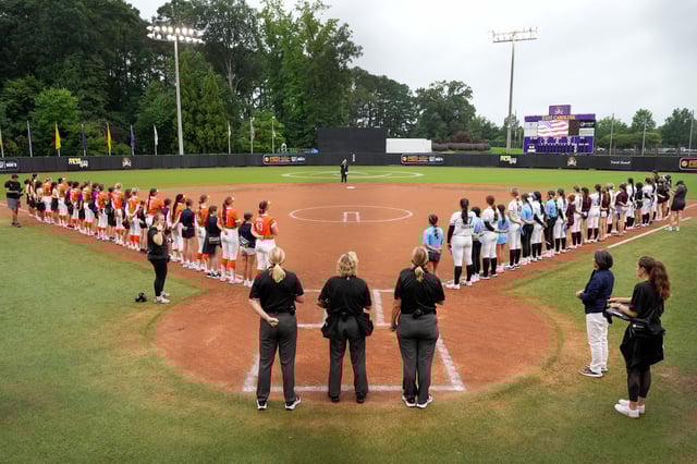 GREENVILLE, NORTH CAROLINA - AUGUST 07:  Team Kilfoil and Team McQuillin starters stand for the national anthem with Little League World Series players during an Athletes Unlimited Pro game at Max R. Joyner Family Stadium on August 07, 2024 in Greenville, North Carolina. (Photo by Grant Halverson/Getty Images)