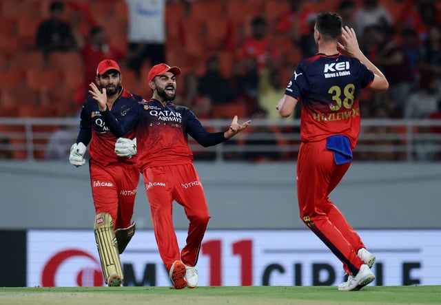 Cricket - Indian Premier League - IPL - Qualifier 1 - Punjab Kings v Royal Challengers Bengaluru - Maharaja Yadavindra Singh International Cricket Stadium, New Chandigarh, India - May 29, 2025 Royal Challengers Bengaluru's Josh Hazlewood celebrates with Virat Kohli after taking the wicket of Punjab Kings' Shreyas Iyer, caught out by Jitesh Sharma REUTERS/Anushree Fadnavis