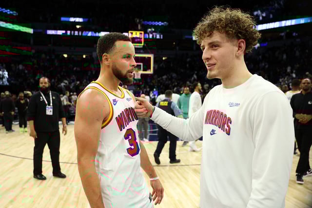 Stephen Curry #30 (L) and Brandin Podziemski #2 of the Golden State Warriors celebrate a victory against the Minnesota Timberwolves after the game at Target Center on December 21, 2024 in Minneapolis, Minnesota. The Warriors defeated the Timberwolves 113-103.