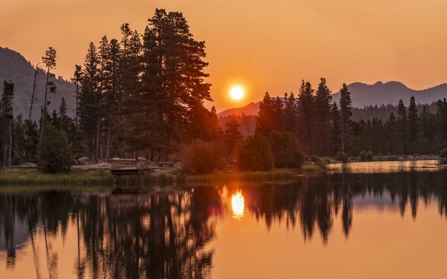 A stock photo of a hazy sun seen through wildfire smoke in Colorado.
