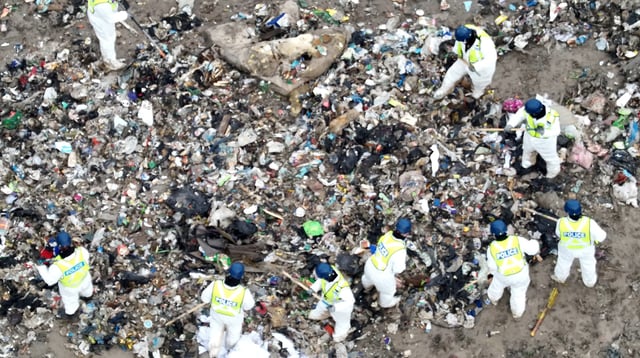 Aerial view of investigators searching the landfill.