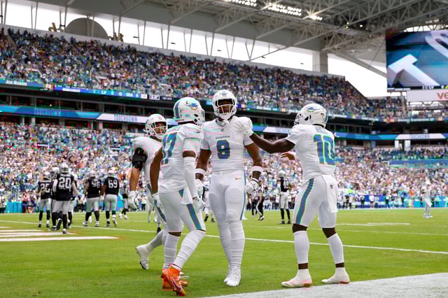 MIAMI GARDENS, FLORIDA - NOVEMBER 17: Jonnu Smith #9 of the Miami Dolphins celebrates after a touchdown catch with Jaylen Waddle #17 and Tyreek Hill #10 during the first half against the Las Vegas Raiders at Hard Rock Stadium on November 17, 2024 in Miami Gardens, Florida.