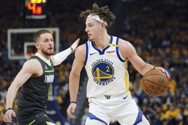 Golden State Warriors guard Brandin Podziemski (2) moves the ball while defended by Minnesota Timberwolves guard Donte DiVincenzo (0) during the first half of Game 3 of an NBA basketball second-round playoff series Saturday, May 10, 2025, in San Francisco. (AP Photo/Godofredo A. Vásquez)